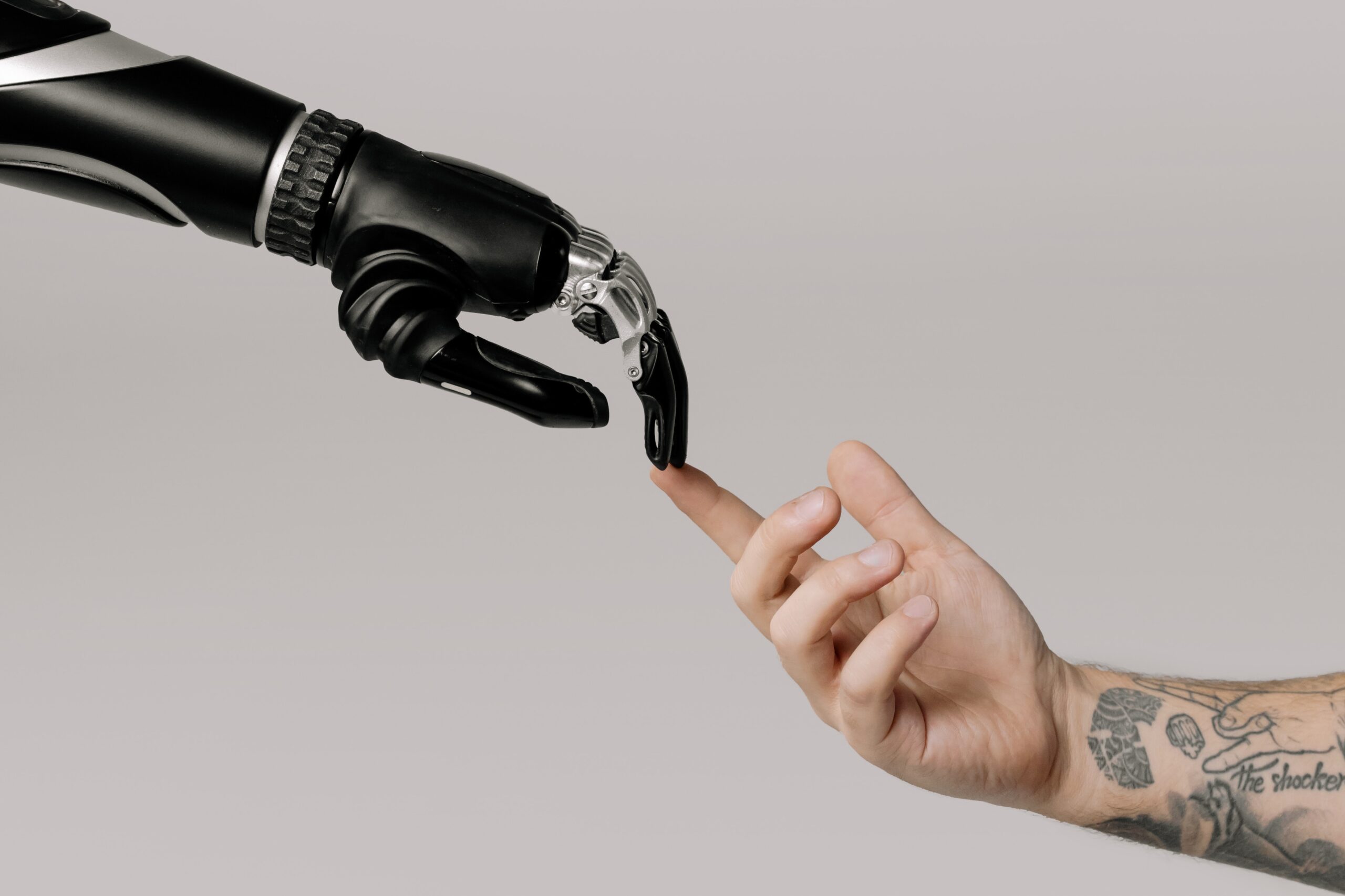 Picture of a human hand touching a robot hand
