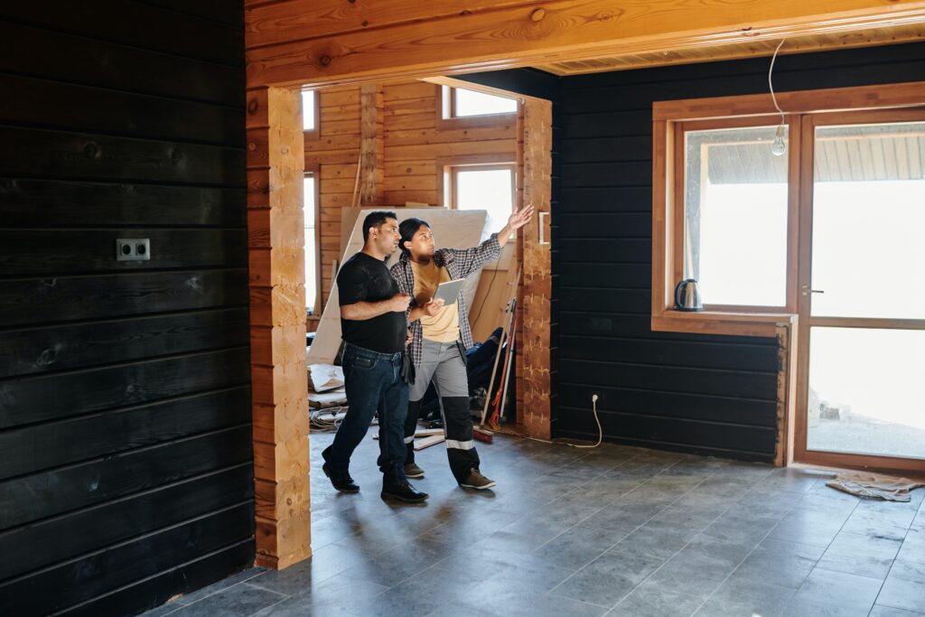 Photo of an interior of a house and contractors walking through the house