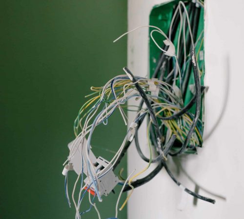 Image of wiring coming out of a wall.