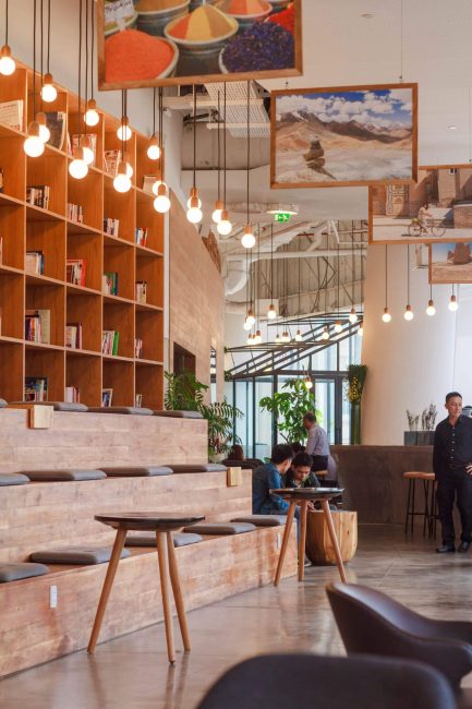 Image of a luxury office lobby with a bookcase and hanging pendants.